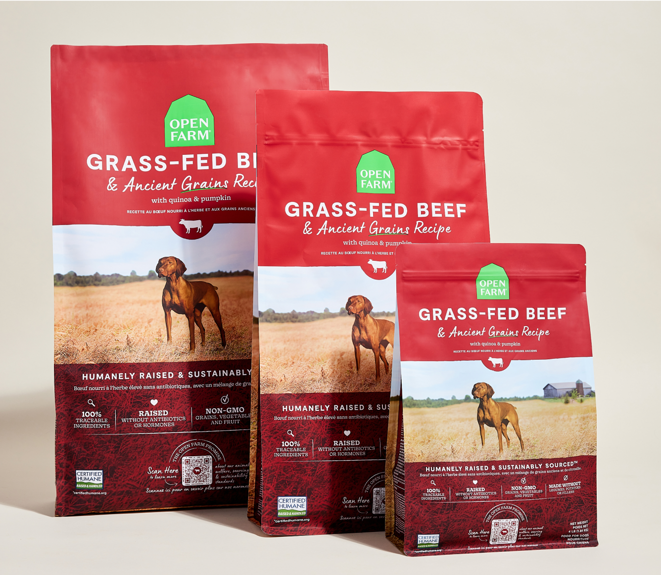 Three packages of Open Farm grass-fed beef dog food on a light background